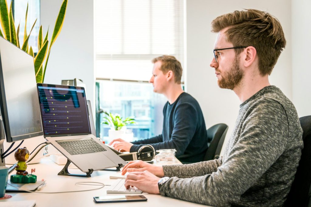 Two people working at laptops